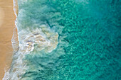 Aerial view of crispy waves along the shoreline at Playa de los Amantes, Cabo San Lucas, Baja California, Mexico.