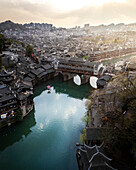 Aerial view of picturesque fenghuang ancient town with traditional architecture and scenic river, Hunan, China.