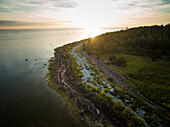 Aerial view of the estonian coastline at sunset on vormsi island.