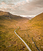 Aerial view of empty curvy mountain road in Norway.