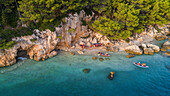 Aerial view of group of kayakers exploring the Adriatic sea coast near the famous city of Makarska in Dalmatia, Croatia.