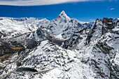 Aerial view of snowcapped Himalayan mountains with Ama Dablam, Kongma la pass, and clear sky, Khumjung, Nepal.