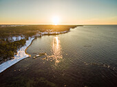 Aerial view of sunset on the snowy coast of Estonia.