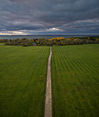 Aerial view of an empty dirt road just before the storm on the island of Vormsi, Estonia