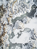 Aerial view of snowy rocky landscape in countryside of Estonia.