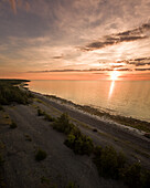 Panoramic aerial view of the Estonian coastline at sunset on Vormsi island.