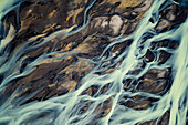 Aerial view of a volcanic river just outside of Villingholt, Iceland. Rivers like this are all over the Icelandic landscape, with colors ranging from yellow to blue to green, Iceland.