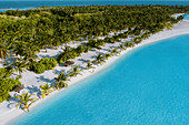Aerial view of a person on a white sand beach with palm trees along the shoreline on South Ari Atoll, Maldives.