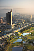 Aerial view of modern skyscrapers and a beautiful golf course in Dubai Marina, Dubai, United Arab Emirates.