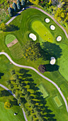 Aerial view of a golf course fairway and sand traps in autumn creating an abstract looking perspective at Arrowhead Golf Course in Wheaton, IL - USA