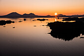 Aerial view of the sun setting behind Kruzof Island, Sitka, Alaska, USA