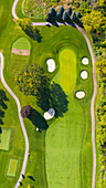 Aerial view of a golf course fairway and sand traps in autumn creating an abstract looking perspective at Arrowhead Golf Course in Wheaton, IL - USA