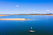 Aerial view of a woman Stand Up Paddle Boarding, Lake Wivenhoe, Queensland, Australia