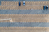 Aerial view of a few cars parked in an empty Parking lot in Cacilhas, Almada, Portugal.