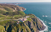 Aerial view of Cabo da Roca lighthouse with majestic coastline looking the Atlantic Ocean, a famous landmark in Colares, Lisbon, Portugal.