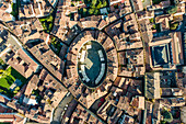 Aerial view of Piazza dell'Anfiteatro, a medieval square with cafè and market in Lucca old town, Tuscany, Italy.