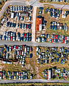 Aerial view of an abandoned junkyard with vehicles parked in a parking lot in Carnide, Lisbon, Portugal.