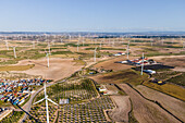 Aerial view of many wind turbines in a wind farm in countryside, La Muela, Zaragoza, Spain.
