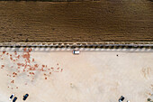 Aerial view of a camper van parking in a parking lot in Obidos near the agricultural fields, Portugal.