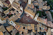 Aerial view of San Gimignano town square with Christmas lights at sunset, Siena, Tuscany, Italy.