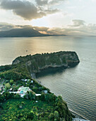 Aerial view of Punta Serra, a small promontory with high cliffs on the Procida island and Ischia Island in background, Flegree Islands archipelagos, Naples, Campania, Italy.