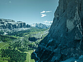 Aerial view of Sassolungo (Langkofel), a mountain peak on the Dolomites mountain range with the Marmolada mountain in background in Trentino, South Tyrol in Northern Italy.