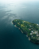 Aerial view of Punta Pizzaco, a beautiful promontory facing the Gulf of Naples on Procida Island with Ischia Island in background, Flegree islands archipelagos, Naples, Campania, italy.