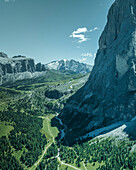Aerial view of Sassolungo (Langkofel), a mountain peak on the Dolomites mountain range with the Marmolada mountain in background in Trentino, South Tyrol in Northern Italy.