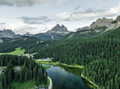 Aerial view of Misurina Lake at sunset with Tre Cime di Lavaredo peaks in background, Auronzo di Cadore, Dolomites, Veneto, Italy.