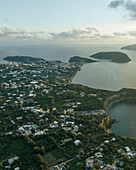 Aerial view of Cala del Vecchio Pozzo with Vivara Island in background, a small bay with high cliffs on the Procida island at sunset, Flegree Islands archipelagos, Naples, Campania, Italy.