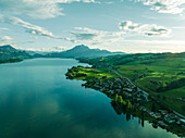 Aerial view of Mount Pilatus at sunset from Lake Lucerne, a mountain peak in Alpnach, Switzerland.