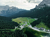Panoramic aerial view of Misurina Lake at sunset with Sorapis mountain in background, Auronzo di Cadore, Dolomites, Veneto, Italy.