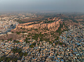 Aerial view of mehrangarh fort amidst the blue cityscape of jodhpur, rajasthan, india.