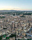 Aerial view of the beautiful medieval city with the iconic Duomo amidst scenic rooftops and charming streets, Siena, Italy.