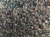 Aerial view of bustling Chandni Chowk with dense urban architecture and vibrant rooftops, Old Delhi, India.