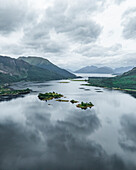 Aerial view of serene Loch Leven surrounded by majestic mountains and lush greenery, Ballachulish, United Kingdom.