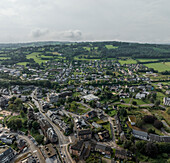 Aerial view of a beautiful village with fields and homes amidst green countryside, Malmedy, Belgium.