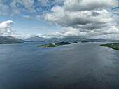 Aerial view of serene Loch Lomond surrounded by majestic mountains and picturesque islands, Trossachs National Park, Scotland, United Kingdom.
