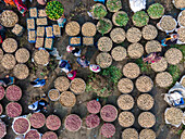 Aerial view of a winter market with fresh vegetable baskets and people selling products, Brahmanbaria, Bangladesh.