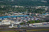 Seattle, United States - 27 May 2020: Aerial view of new airplanes at Boeing Field with runway and cityscape, Seattle, United States.