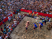 Chittagong, Bangladesh - 25 April 2023: Aerial view of traditional wrestling competition with crowd and athletes in sand arena, Chittagong, Bangladesh.