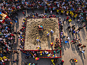 Aerial view of traditional wrestling competition with vibrant crowd and colorful arena, Chittagong, Bangladesh.