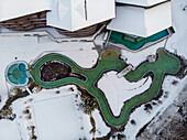 Aerial view of outdoor swimming area covered in snow in winter, Valais, Switzerland.