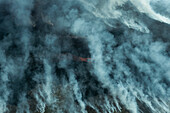 Aerial view of a mystical landscape with smoke and dramatic clouds, Grindavik, Iceland.