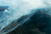 Aerial view of majestic volcanic landscape with smoke and ash, Grindavik, Iceland.