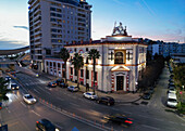 Aerial view of bustling downtown with BKT bank building and palm trees at sunset, Durres, Albania.