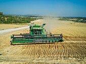 Aerial view of cultivated farmland with tractor and lines, Central District, Israel.