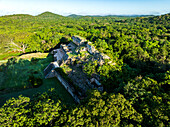 Aerial view of ancient Mayan ruins surrounded by lush jungle and greenery, Santa Elena, Mexico.