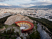 ATHENS, GREECE - 13 JANUARY 2020 : Aerial view of the hill housing Lycabettus Theatre and the city of Athens in the background, Greece.