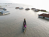 Kurigram, Bangladesh - 22 June 2022: Aerial view of flood water and boats in a submerged village with homes affected by disaster, Jatrapur, Kurigram, Bangladesh.